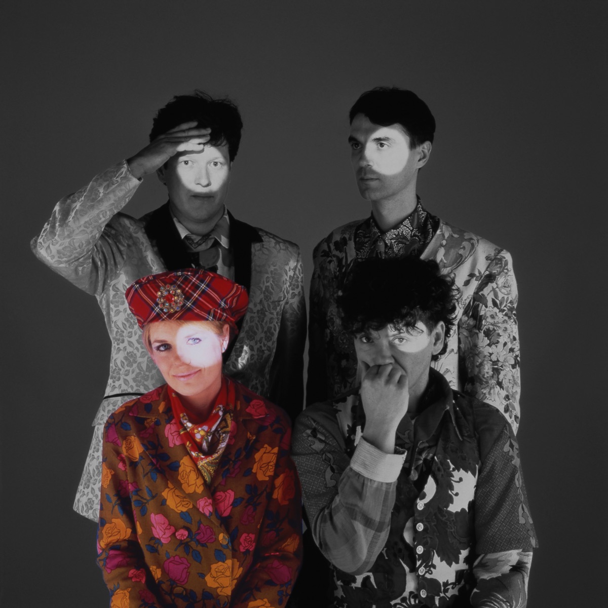 The Name of This Band Member is Tina album artwork: Talking Heads against a dark background, with Tina Weymouth in color and the other members in black and white.