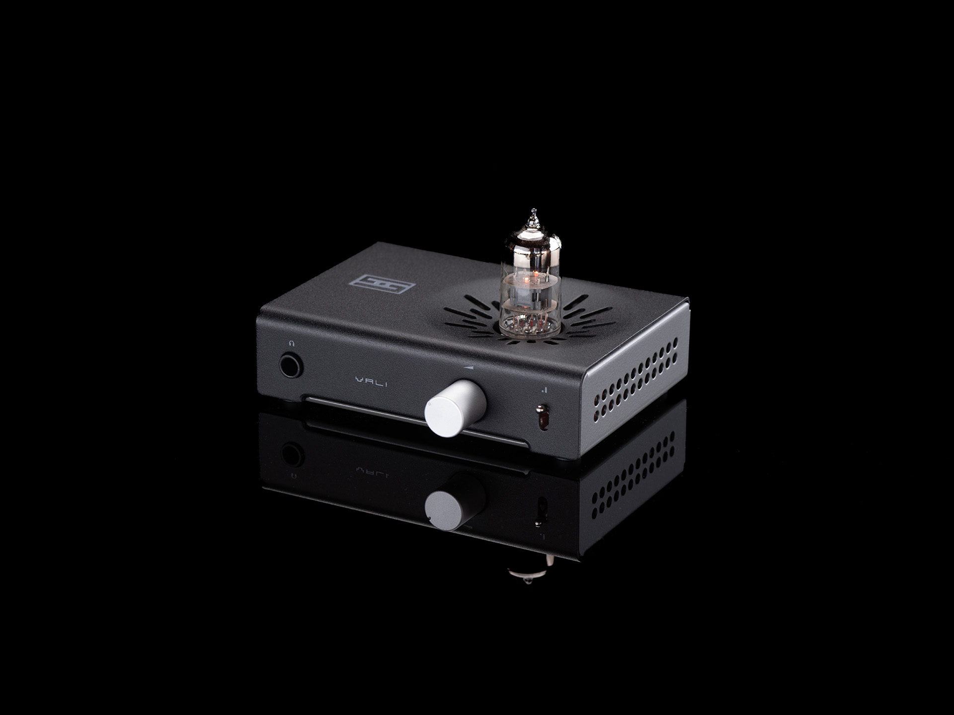 Black Schiit Vali 3 headphone amplifier with an exposed glass tube and silver volume knob